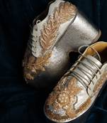 Gold leather embroidered sneakers