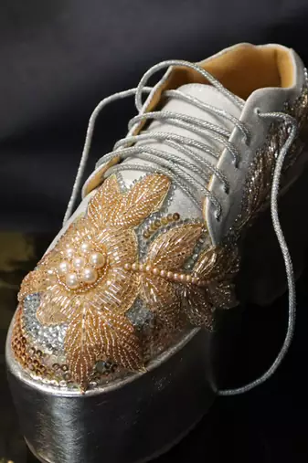 Gold leather embroidered sneakers