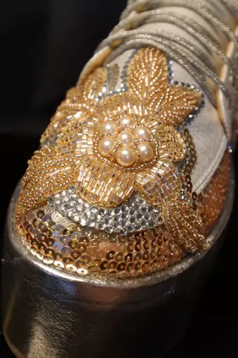 Gold leather embroidered sneakers