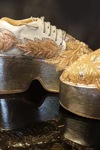 Gold leather embroidered sneakers