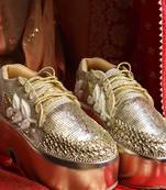 Gold leather embroidered sneakers