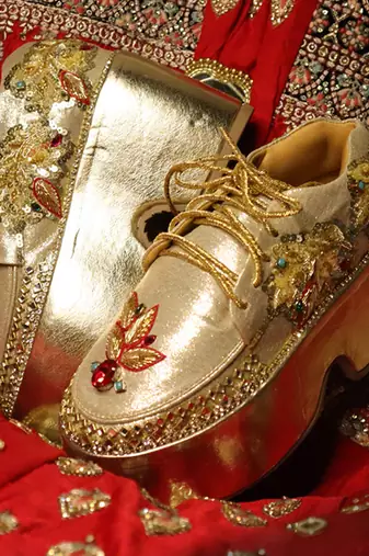 Gold leather embroidered sneakers