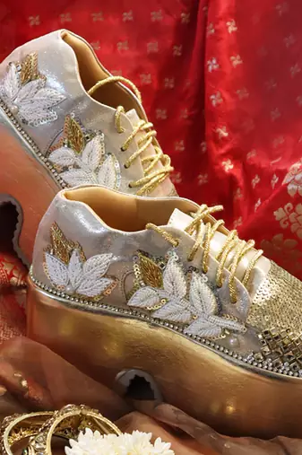 Gold leather embroidered sneakers