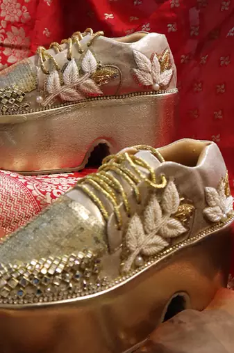 Gold leather embroidered sneakers