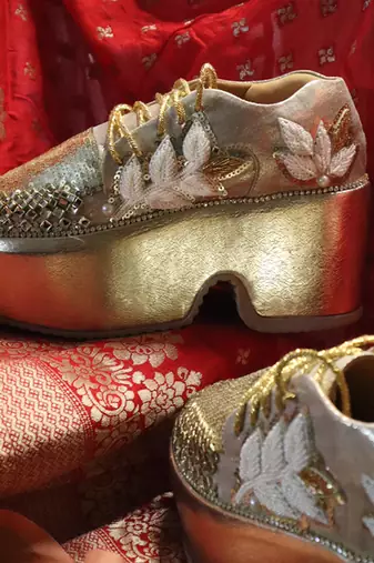 Gold leather embroidered sneakers