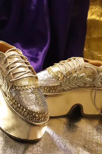 Gold leather embroidered sneakers