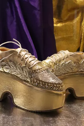 Gold leather embroidered sneakers