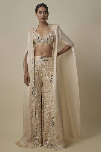 Beige satin embroidered pant and blouse paired with plain cape
