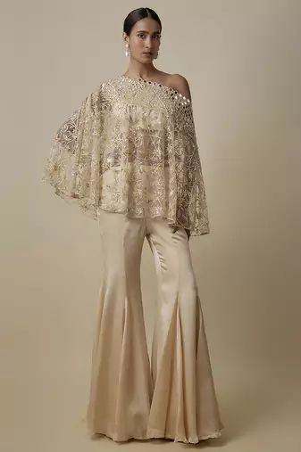 Beige satin plain blouse and pant paired with embroidered cape