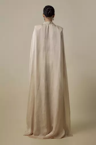Beige satin embroidered pant and blouse paired with plain cape
