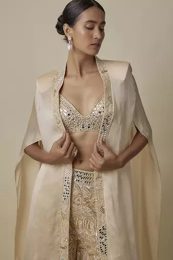 Beige satin embroidered pant and blouse paired with plain cape