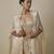 Beige satin embroidered pant and blouse paired with plain cape