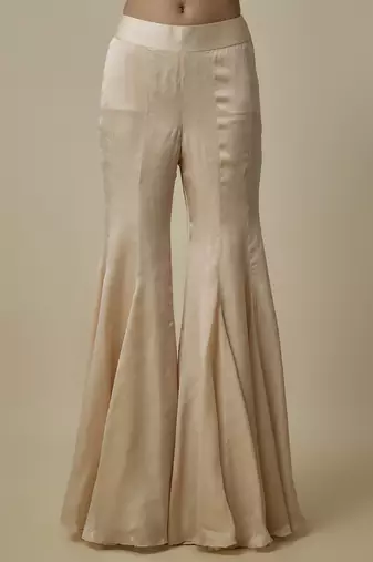Beige satin plain blouse and pant paired with embroidered cape