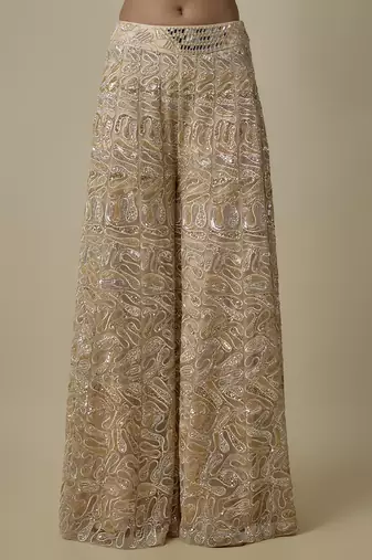 Beige satin embroidered pant and blouse paired with plain cape
