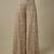 Beige satin embroidered pant and blouse paired with plain cape