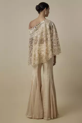 Beige satin plain blouse and pant paired with embroidered cape