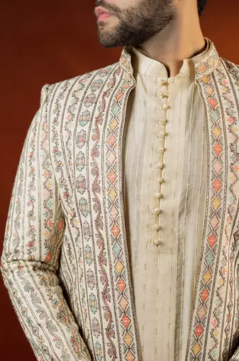 Cream heavy embroidered front open sleeveless jacket kurta set