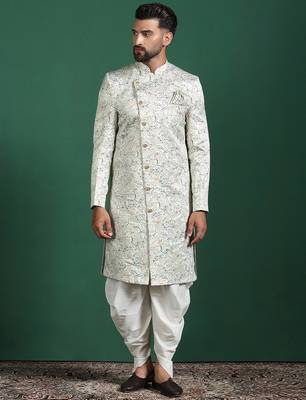 Cream sherwani dhoti set with paisley design     subtle indian groom outfit 2