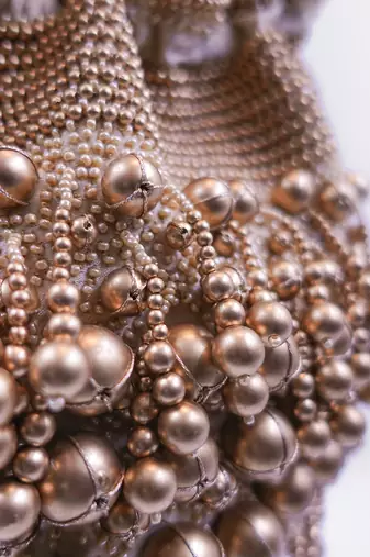 Embellished golden potli bag with drawstring