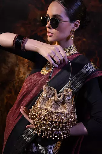 Embellished golden potli bag with drawstring
