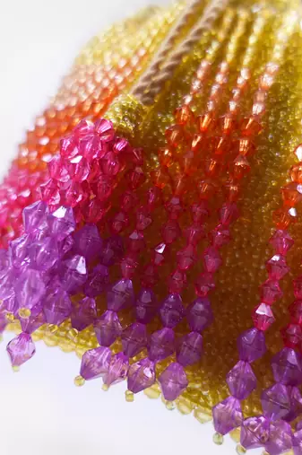 Handcrafted yellow ombre potli bag with crystal fringes and drawstring closer
