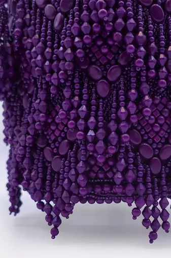 Handcrafted purple potli bag adorned with intricate bead embellished