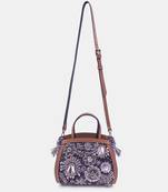 Silver embroidered bead-embellished clutch bag with crossbody strap.