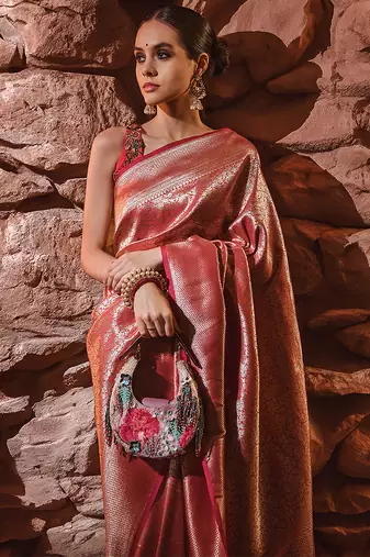 Pink bead-embellished clutch bag with detachable leather crossbody strap