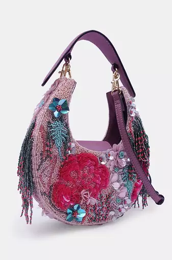 Pink bead-embellished clutch bag with detachable leather crossbody strap
