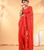 Red mulmul cotton saree with floral embroidery and tassel detailing
