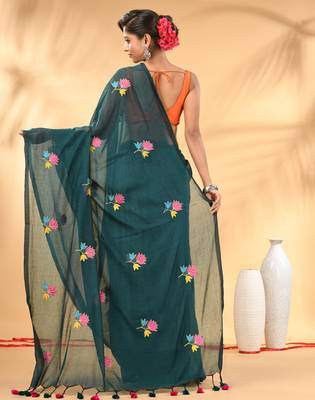 Teal mulmul cotton saree with floral embroidery and tassel detailing 3