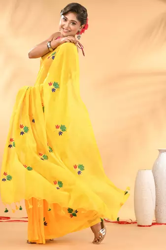 Yellow mulmul cotton saree with floral embroidery and tassel detailing
