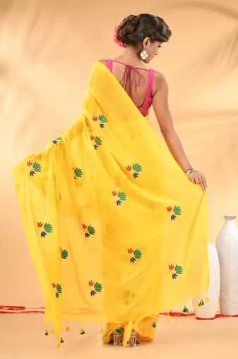 Yellow mulmul cotton saree with floral embroidery and tassel detailing