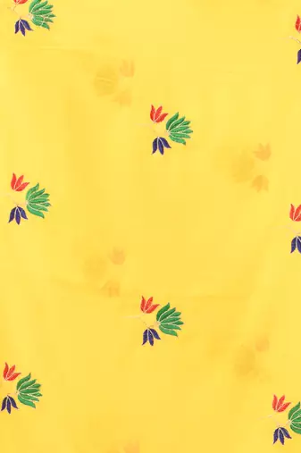 Yellow mulmul cotton saree with floral embroidery and tassel detailing