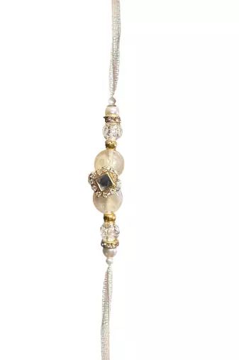 Traditional crystal & pearl rakhi – beautiful gold tassel design for brother and bhabhi