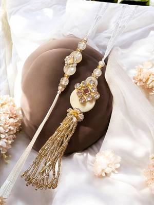 Traditional crystal & pearl rakhi – beautiful gold tassel design for brother and bhabhi 1