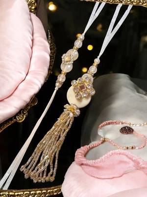 Traditional crystal & pearl rakhi – beautiful gold tassel design for brother and bhabhi 4