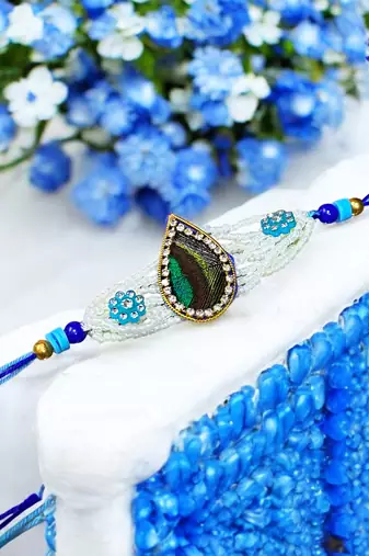 Peacock feather rakhi for brother – traditional handcrafted design with
vibrant colors