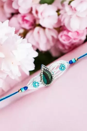 Peacock feather rakhi for brother – traditional handcrafted design with
vibrant colors