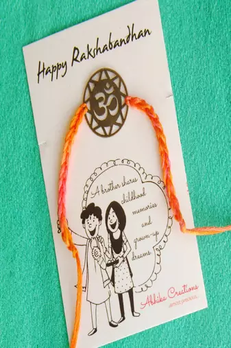 Om quirky rakhi with roli chawal capsules