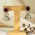 Golden glamour antique jhumka earrings with green stone & pearl detailing