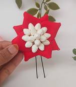 red metal brooch with petal flower design