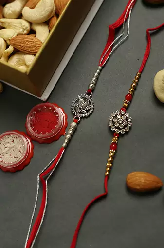 Elegant Stone Rakhi Duo with Kaju Badam, Assorted Chocolates & Dairy Milk – Set of 2