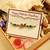 Om Rakhi with Flute & Peacock Design – Dry Fruits & Chocolate Gift Hamper