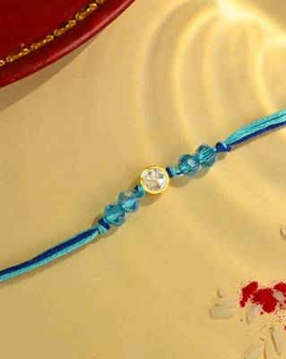 Blue thread rakhi with gold-framed stone and crystal beads 1
