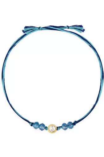 Blue thread rakhi with gold-framed stone and crystal beads