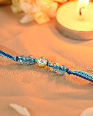 Blue thread rakhi with gold-framed stone and crystal beads 3