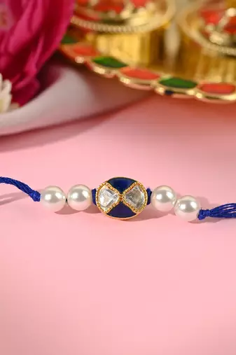 Navy blue thread rakhi with dual stone charm and pearl beads