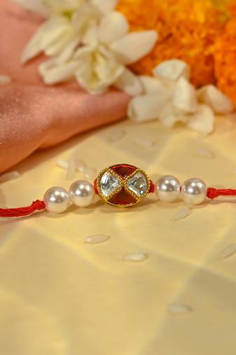 Red thread rakhi with oval dual stone charm and pearl beads