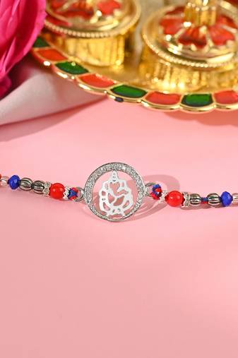 Multicolour thread rakhi with ganpati charm and beaded detail
